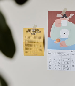 two calendars on a white wall