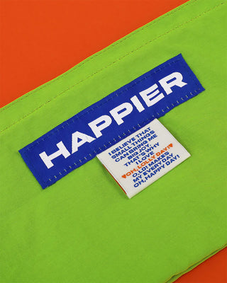 Textile label with 'HAPPIER' on a green and orange background