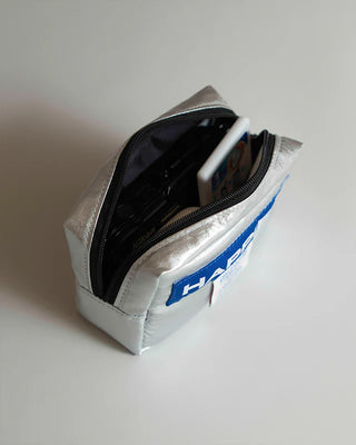 Silver pouch with a blue label on a white background