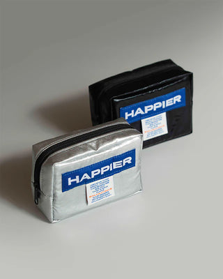 Two pouches with 'Happier' branding on a gray background