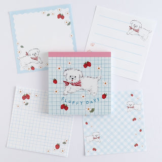 Memo pad pages with cartoon dog illustrations on a light blue background