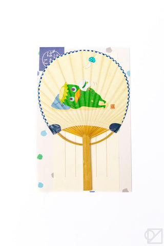 Decorative fan with a colorful kappa design on a white background