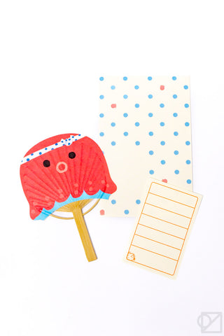 Red octupus fan and stationery on a white background