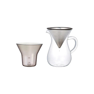 Clear glass coffee brewing set with pitcher and filter on a white background