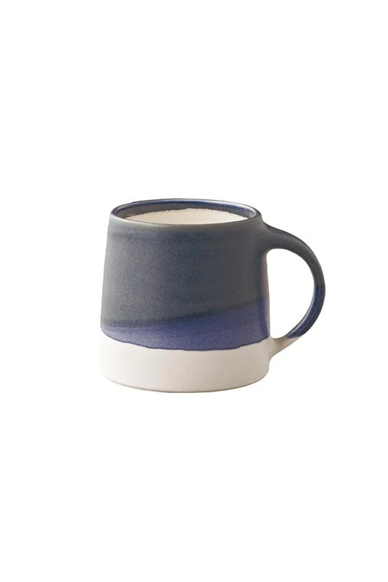 Navy and white ceramic coffee mug with curved handle and speckled glaze band