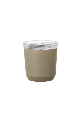 Beige tumbler with a clear lid on a white background