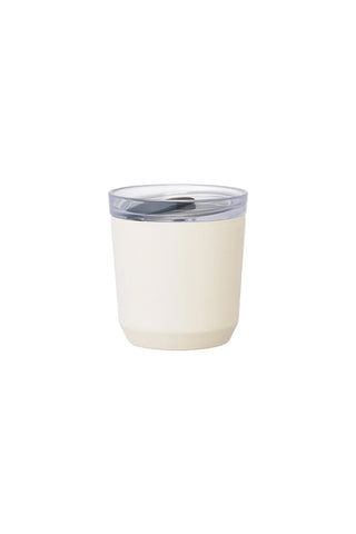White tumbler with a clear lid on a white background