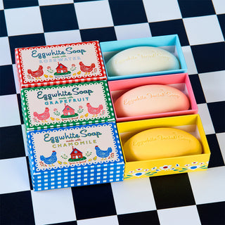 Set of Eggwhite Soap bars in colorful packaging on a checkered background