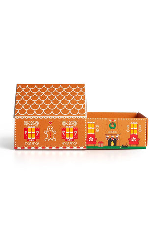 Open gingerbread matchbox cottage interior with colorful storefront scene graphics