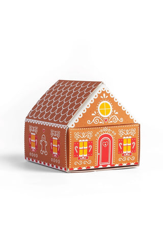 Gingerbread matchbox cottage with orange scallop roof and festive window graphics
