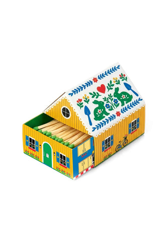 Colorful match box house with decorative elements on a white background