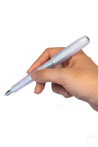 Iridescent pearl fountain pen held in hand; light blue translucent body
