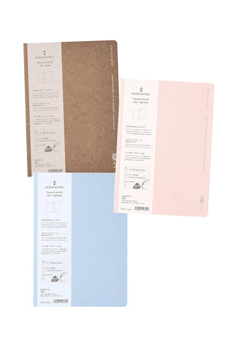 B6 2mm grid notebooks in brown, light pink, and light blue, shown with packaging inserts