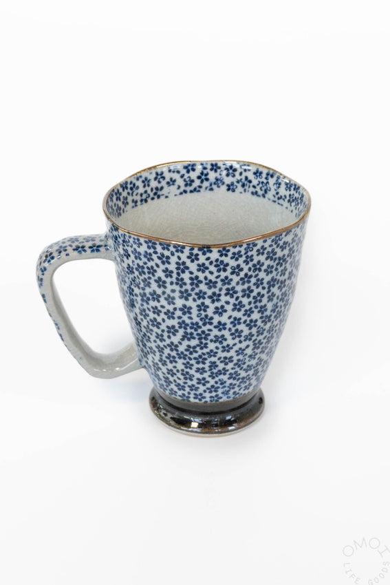 12 oz ceramic mug with blue speckled floral pattern and curved handle