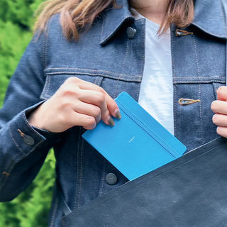 Blue log diary with strap, held in hand, 'TODAY' on cover