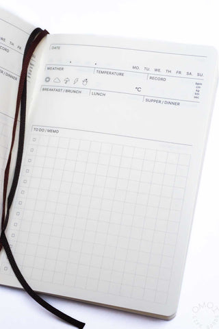 Open log diary page with weekly grid and “to do / memo” sections