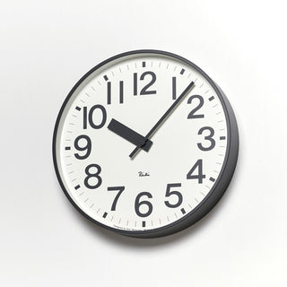 Round aluminum clock with white dial, bold black numerals, and black hour/minute hands.