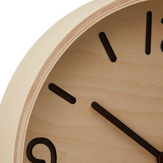 Close-up of natural wood clock face with black hour and minute hands
