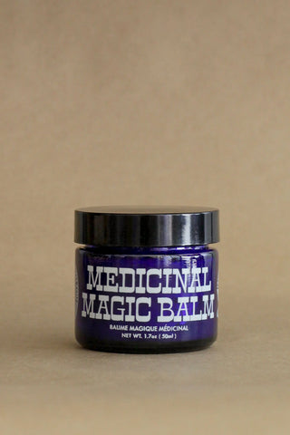 Jar of 'Medicinal Magic Balm' on a beige background
