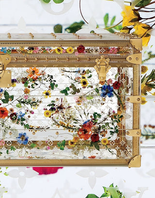 Decorative case with floral design and gold accents on a white background