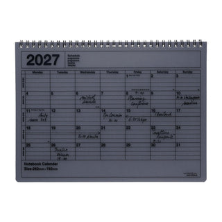 Black monthly notebook calendar on a light background