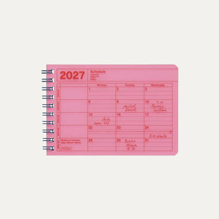 Small neon pink monthly calendar on a light background