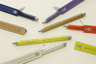 Collection of pens and colorful packaging on a light background