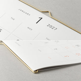 MD 2027 hanging wall calendar close-up, gold wire hanger and January 7, 2027.
