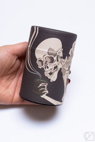Dark textured tea canister with ukiyo-e skeleton artwork on the front
