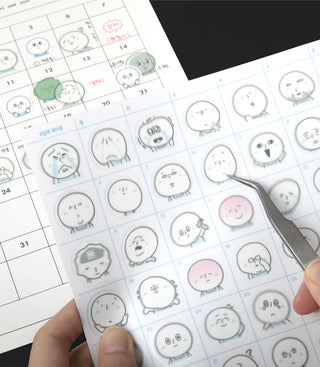 Sheet of small round stickers with cartoon character making different facial expressions