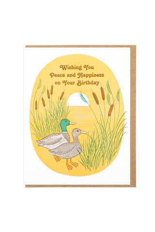 Birthday card with mallard ducks in tall grass and gold circular design with greeting text