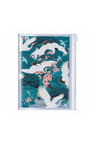 planner with cover of crane birds, flowers and other nature elements on a green background