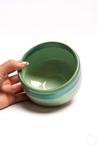 Seafoam ceramic matcha bowl held in hand, interior glossy green