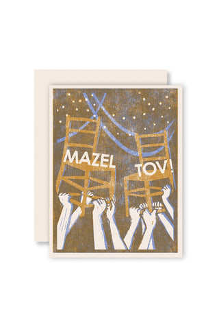 Greeting card with 'Mazel Tov' design featuring hands holding up chairs on a gold background.