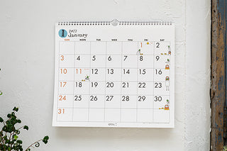 2027 February wall calendar mounted on a wall, with a monthly date grid