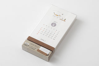Angled 2027 cat desk calendar on wooden stand with monthly date layout