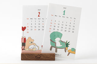 2027 desk calendar stand with two calendar pages, dog illustrations for days 1 and 2
