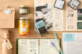 Cat stamp designs on paper cards and notebooks on a desk