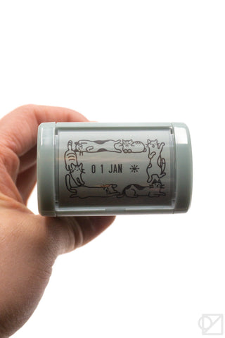 Handheld rotary date stamp showing 01 JAN with cat illustration