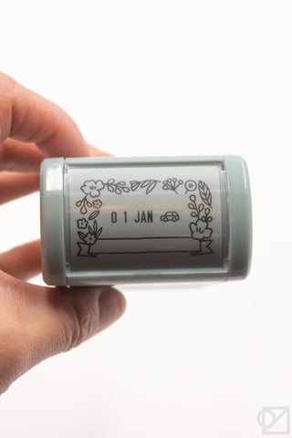 Mint floral date stamp roller with January border design, close-up