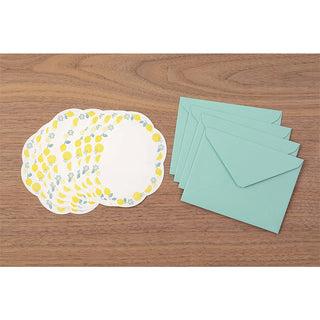 Stationery set with letterpress sheets and matching envelopes on a wooden table