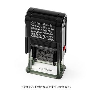 Paintable rotary stamp with black handle and floral pattern, clear base and red knob