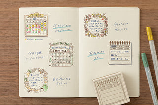 Open memo planner with stamped calendar and checklist motifs and stamp block