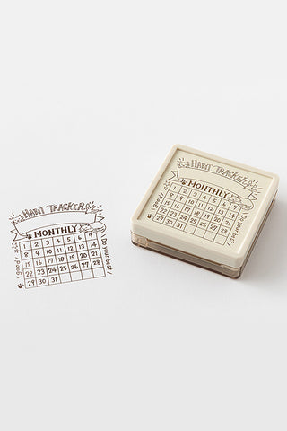 Beige paintable block stamp featuring monthly habit tracker grid calendar