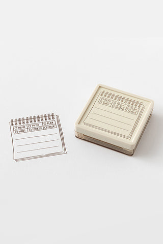 Beige paintable memo block stamp with inked checklist example on paper