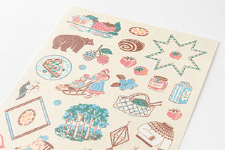 Close up of Midori Finland planner stickers with brow, blue, green, and red color scheme