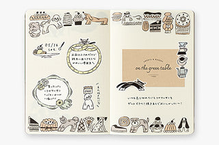 B6 dot grid notebook open spread with animal and sweets illustrations and labels