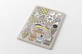 B6 dot grid notebook closed, beige cover with whimsical animal and sweets icons