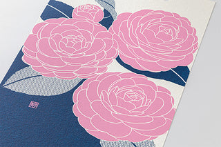 Floral calendar close-up with large pink peony blossoms on blue background
