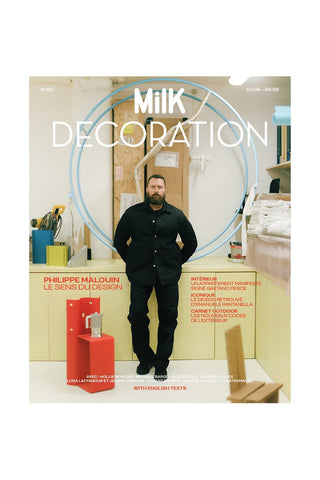 MilK Decoration N°62 magazine cover with model in black outfit and blue circular logo
